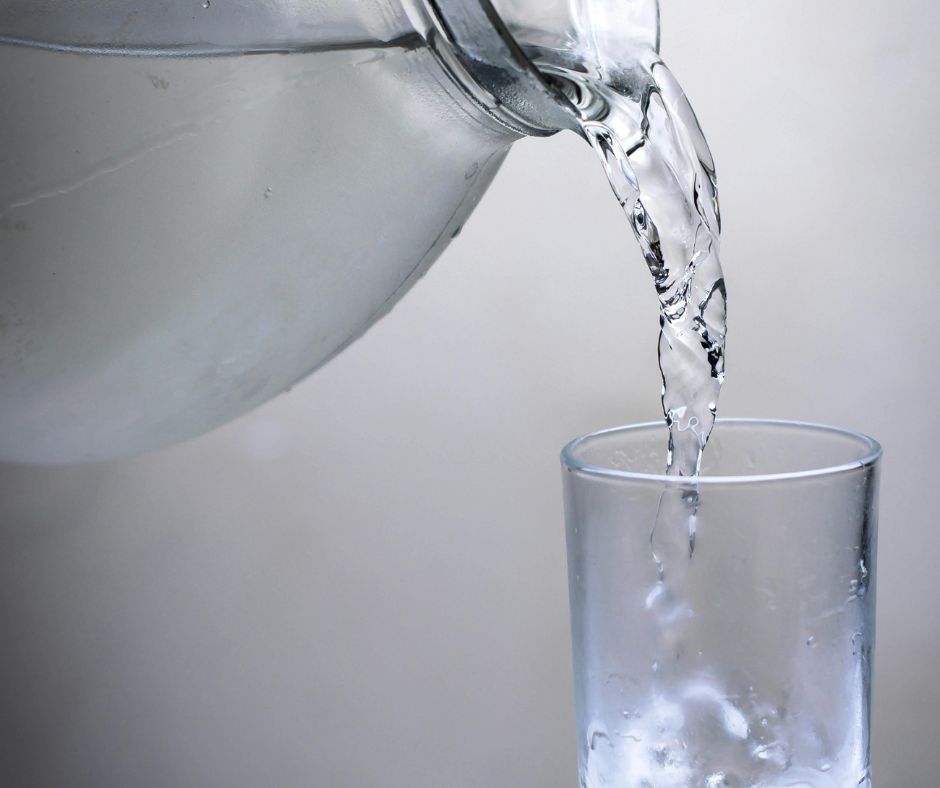 Filling a glass with cold water from a pitcher