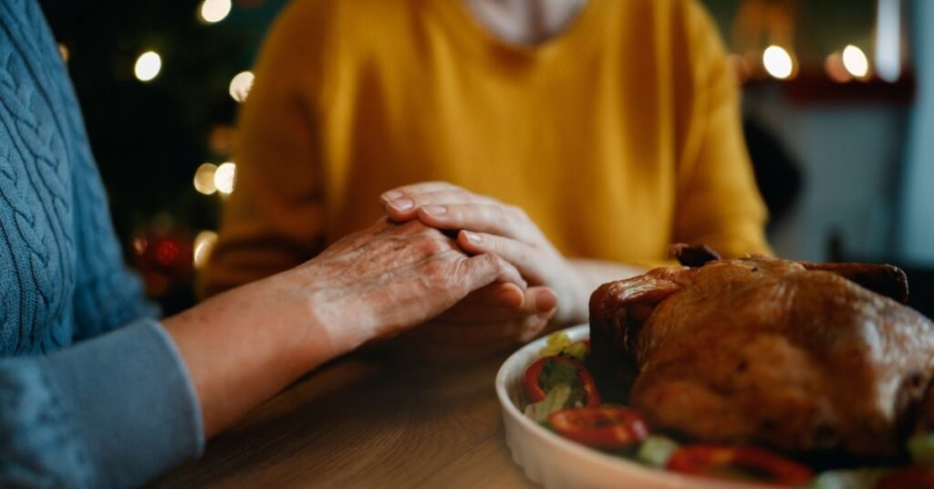 aging-woman-and-family-member-at-holiday-dinner