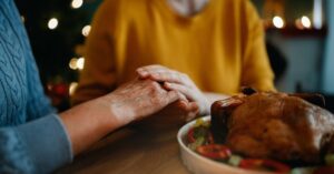 aging-woman-and-family-member-at-holiday-dinner