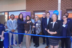 JEVS Human Services CEO flanked by SVP of Home Care Katie Brooks and Senior Director of Home Care Beverly Ward are surrounded by attendees as they cut the ribbon to officially open JEVS Care at Home's Dover, DE office